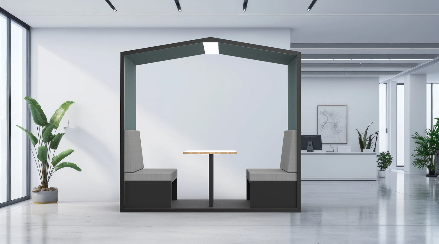 Modern office interior with a small meeting area featuring a table and chairs.