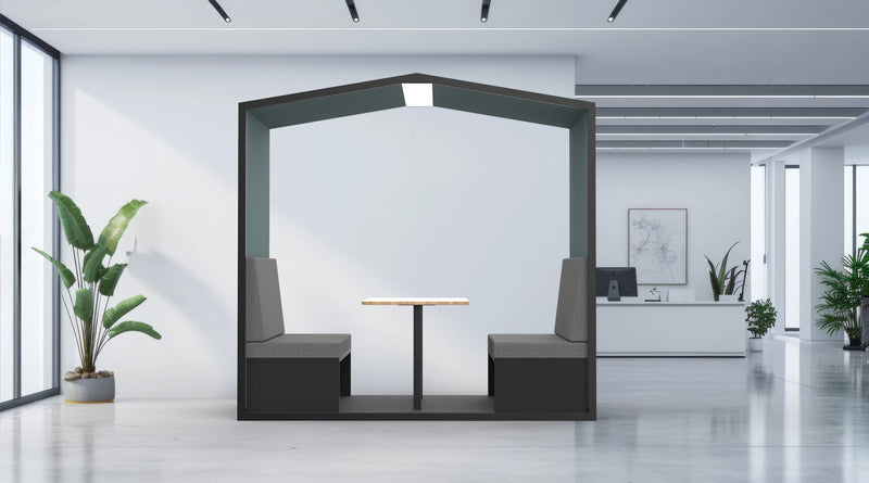 Modern office interior with a small meeting area featuring a table and chairs.