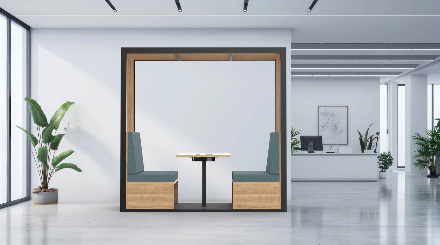 Modern office interior with a partitioned work area, plants, and a desk.