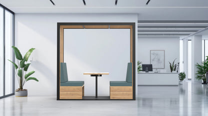 Modern office interior with a partitioned work area, plants, and a desk.