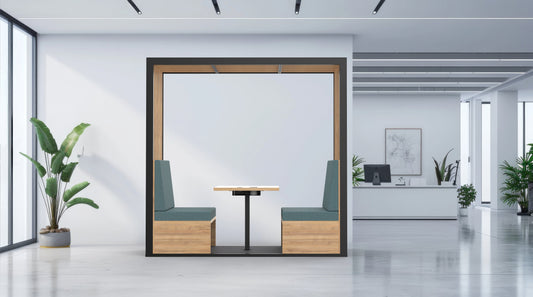 Modern office interior with a partitioned work area, plants, and a desk.