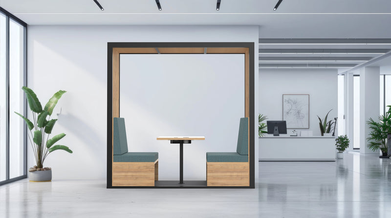 Modern office interior with a partitioned work area, plants, and a desk.