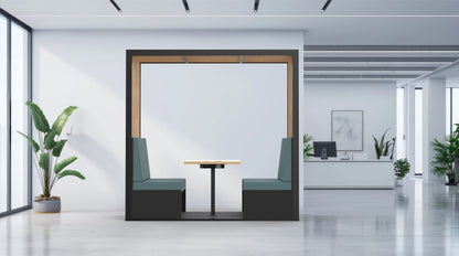 Modern office interior with a glass partition, desk, and plants.